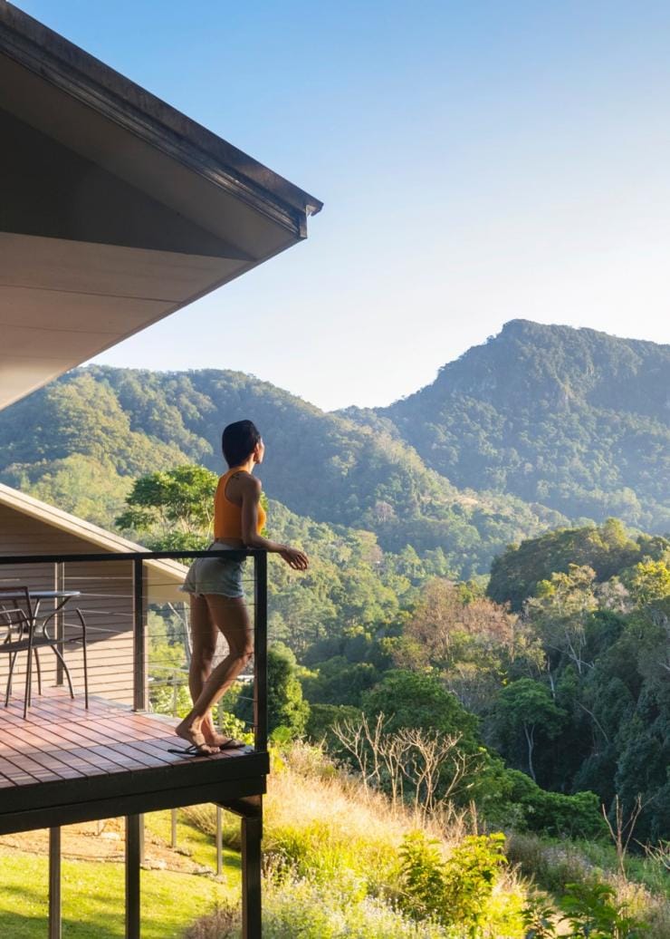 A woman standing on a balcony overlooking bushland at Eden Health Retreat, Currumbin Valley, Queensland © Eden Health Retreat