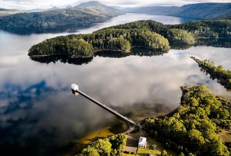 Aerial of thePumphouse Point floating accommodation  and greenery around Lake St Clair, Tasmania © Tourism Tasmania