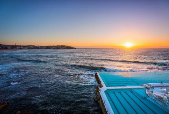 Morning sun rising over Bondi Icebergs, Bondi Beach, NSW © Destination NSW