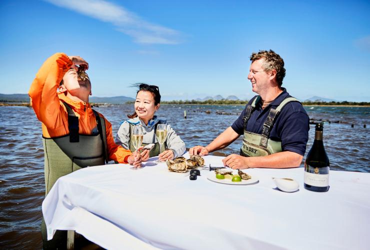 Couple enjoying the Saffire Freycinet Marine Oyster Farm Experience, Freycinet National Park, TAS © Tourism Tasmania