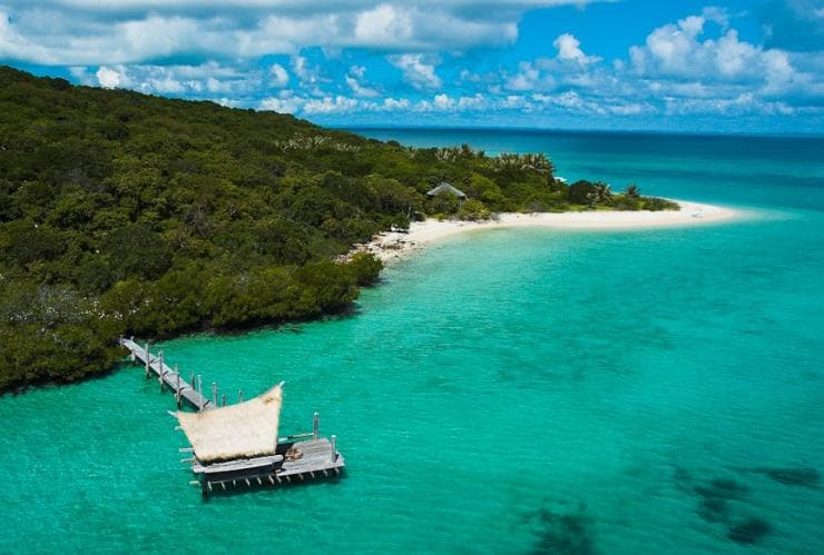 Aerial view over a pier surrounded by turquoise water on Haggerstone Island, Great Barrier Reef, Queensland © Haggerstone Island