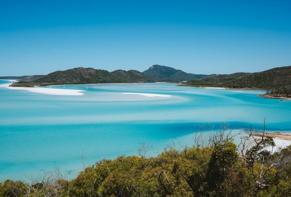 View from a lookout over the blue waters of Whitehaven Beach, Whitsundays, Queensland © Tourism Australia
