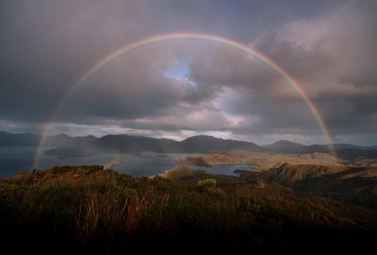 Rainbow over Bathurst Harbour and the surrounding wilderness in Southwest National Park, Tasmania © Emilie Ristevski