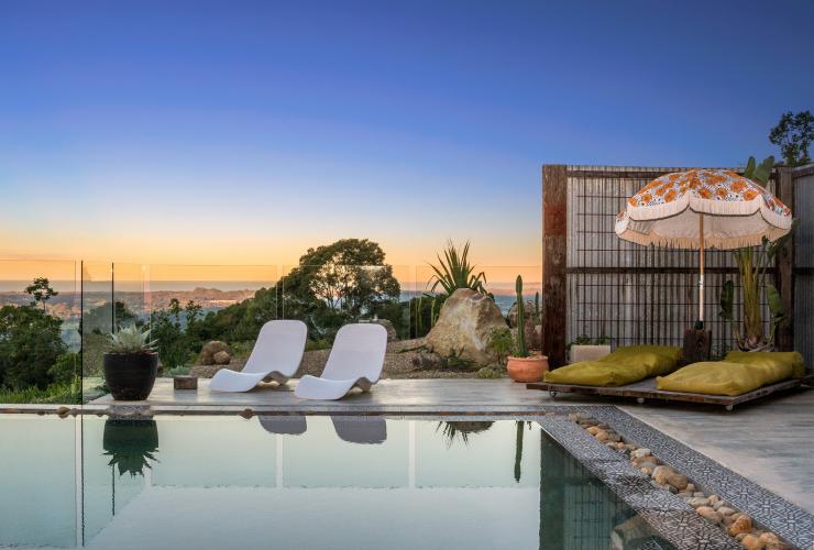 Chairs and lounges beside a pool overlooking the ocean during sunset at Blackbird, Bryon Bay, New South Wales © Blackbird/Saul Goodwin @propertyshotphotography