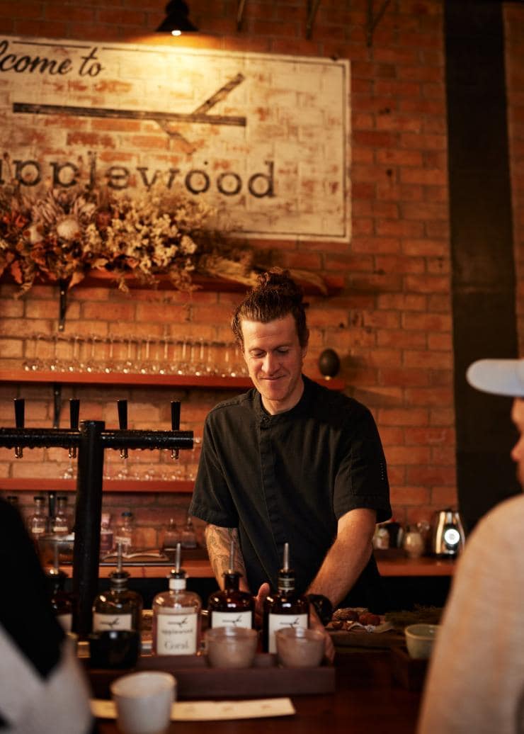 Bartender serving spirits at Applewood Distillery, Adelaide, SA © South Australian Tourism Commission