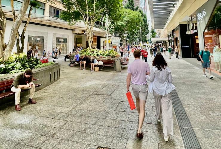 Two people walking arm in arm through a busy shopping strip with Urban Tours, Brisbane, Queensland © Urban Tours