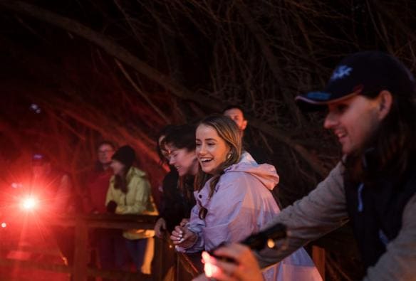 A tour group smiles as they look for little penguins with Bicheno Penguin Tours, Bicheno, Tasmania © Tourism Australia