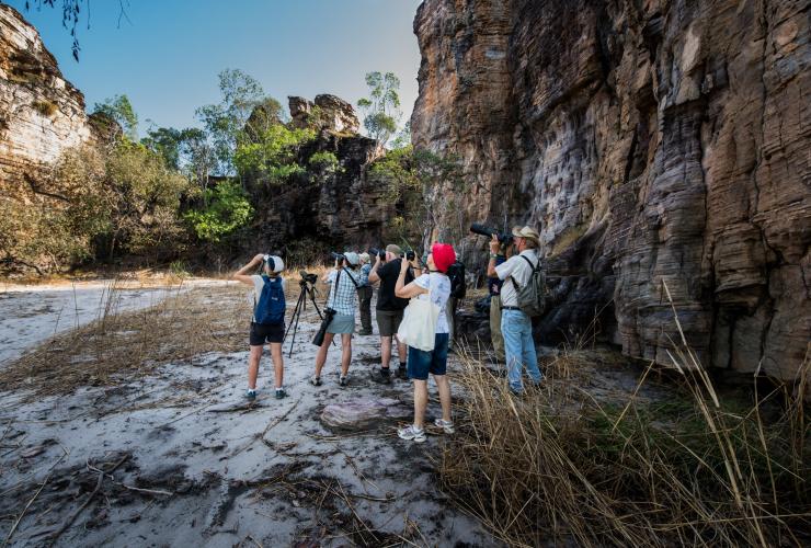 A group of birdwatchers with binoculars along the Bardedjilidji Walk, Kakadu National Park, Northern Territory © Tourism NT/Navin Chandra
