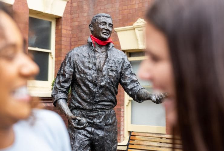 Two women with a statue of cricketer Richie Benaud at the Sydney Cricket Ground, Sydney, New South Wales © Destination NSW 
