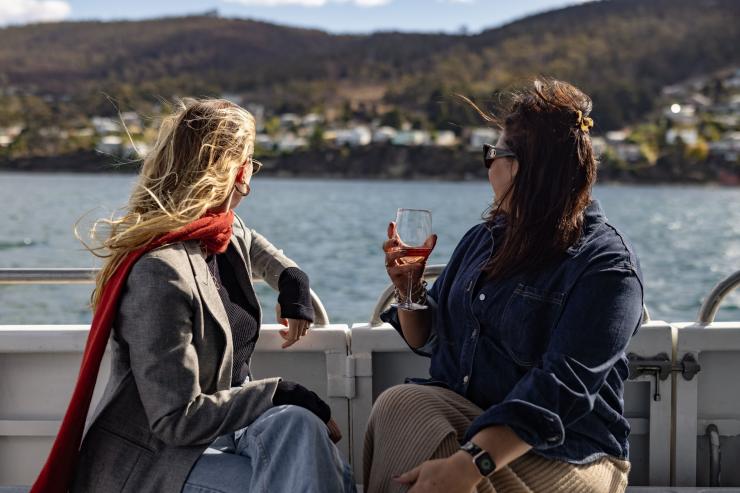 Two women on the back of a boat on a tour with Tasmanian Wild Seafood Adventures, Hobart, Tasmania © Dearna Bond
