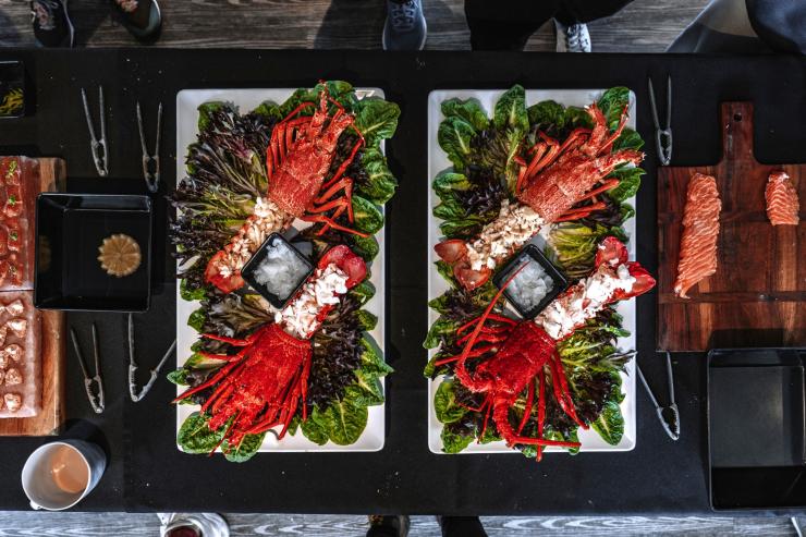 Bright red lobster on platters on a tour with Tasmanian Wild Seafood Adventures, Hobart, Tasmania © Tourism Australia