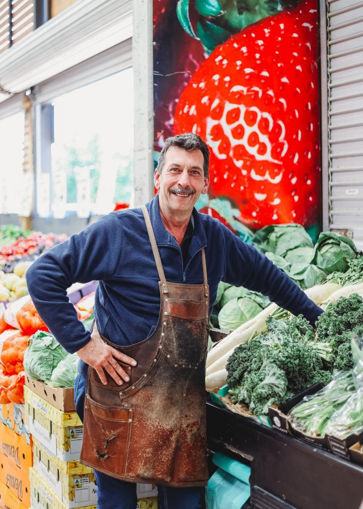 A salesman smiles at the camera next to his produce at the Fyshwick Fresh Food Markets, Canberra, Australian Capital Territory © Fyshwick Fresh Food Markets