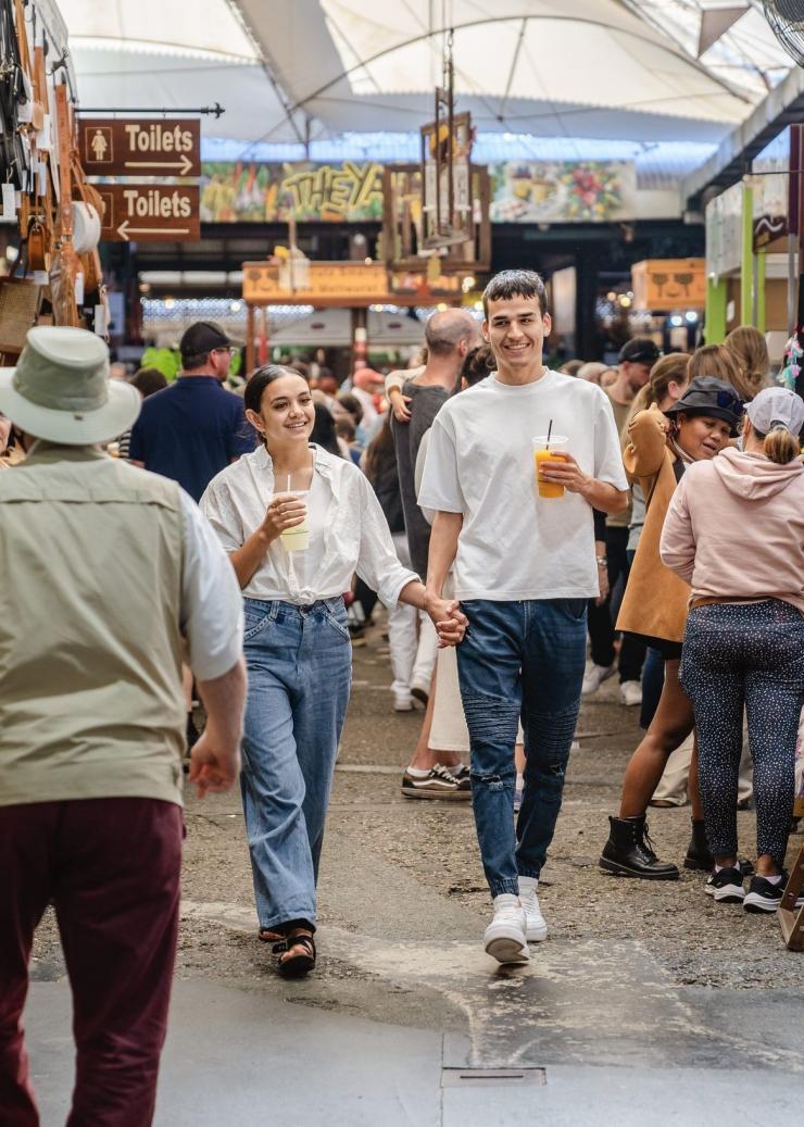 A couple walking through bustling stalls at Fremantle Markets, Perth, Western Australia © Tourism Australia