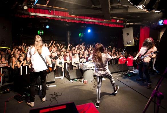 維多利亞州里奇蒙Corner Hotel內樂隊在台上表演，台下的人群在空中揮手©Zo Damage